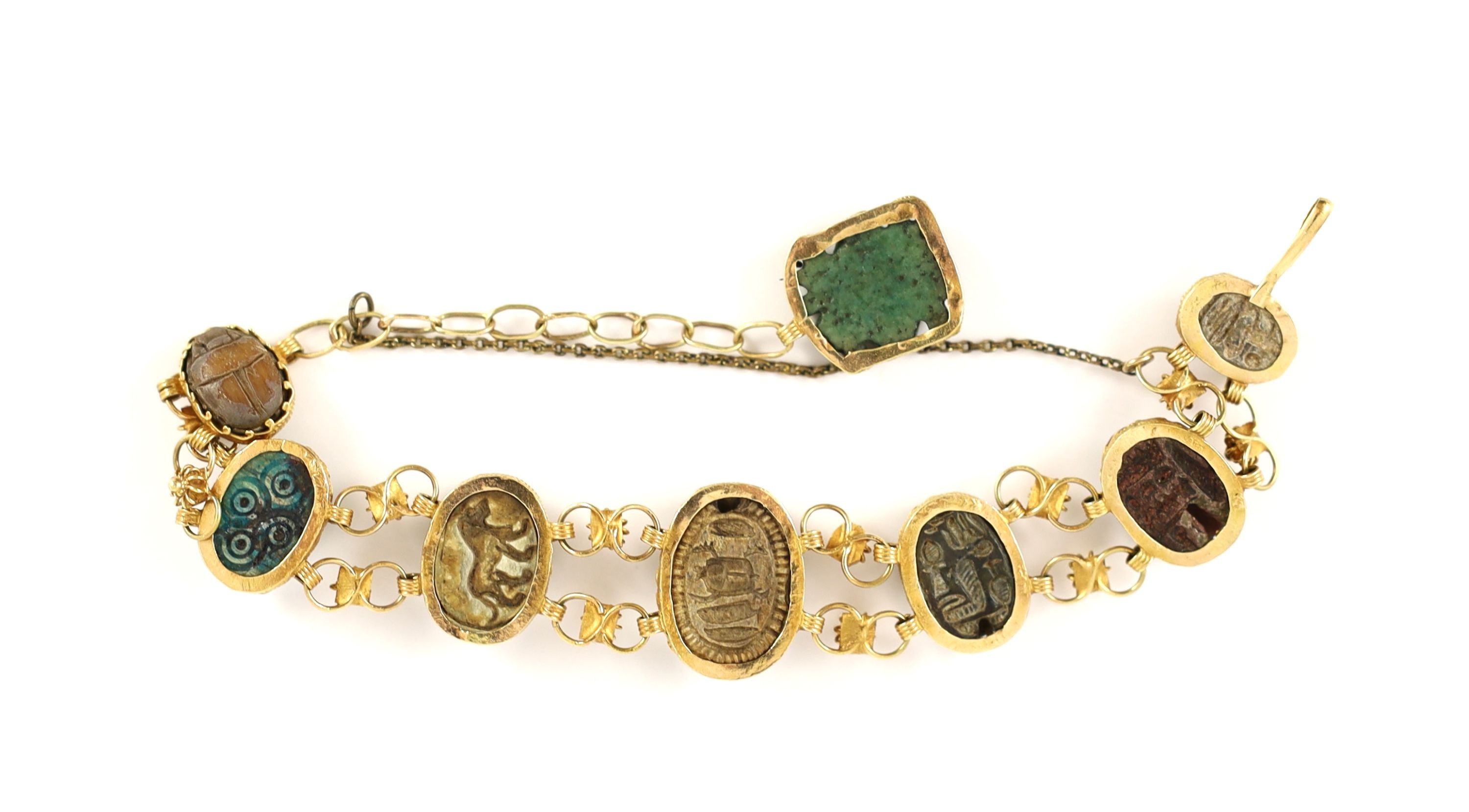 A 19th century gold and graduated seven antique stone scarab set bracelet